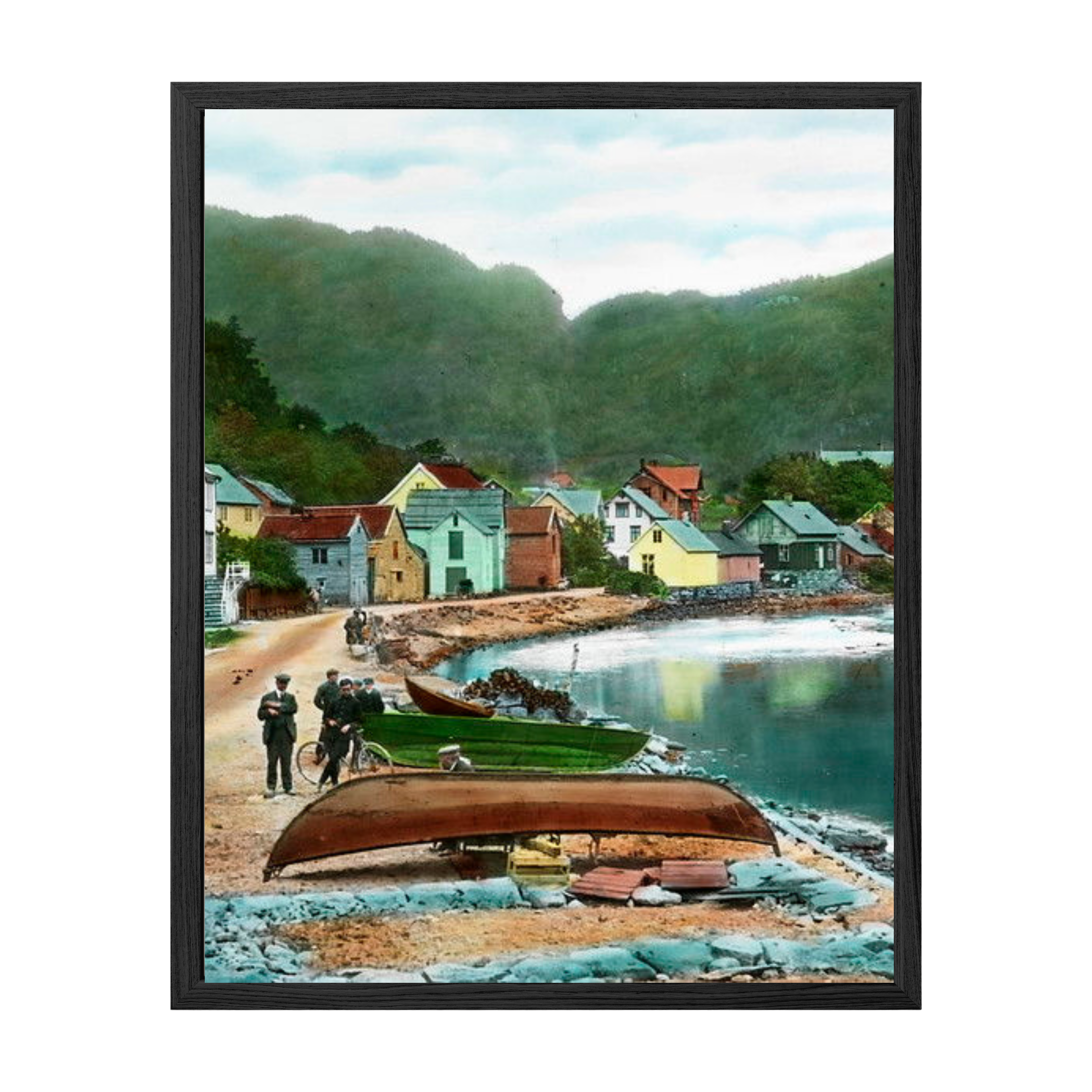 Framed artwork of a coastal village scene with houses and boats.