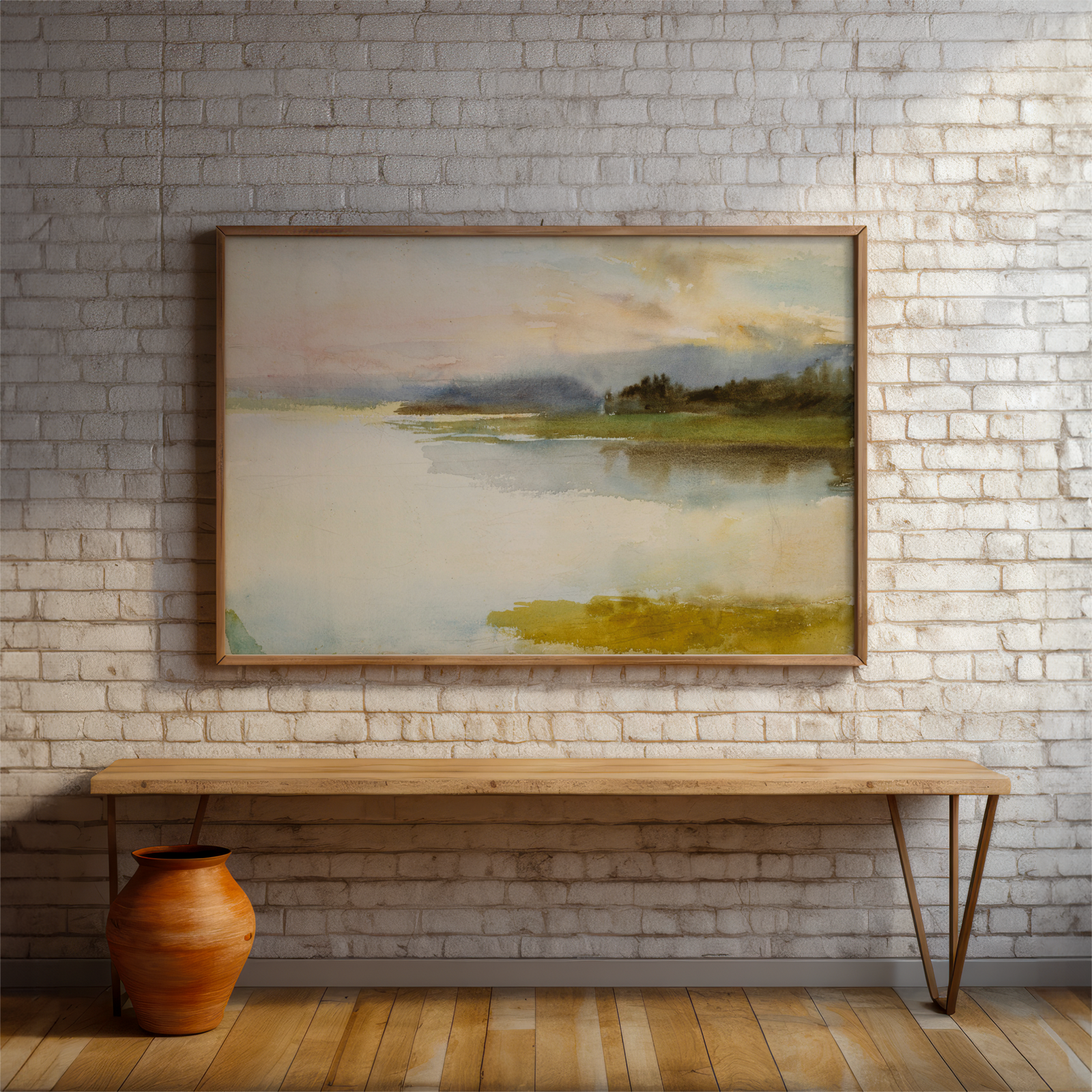 Framed landscape painting on a brick wall above a wooden bench.