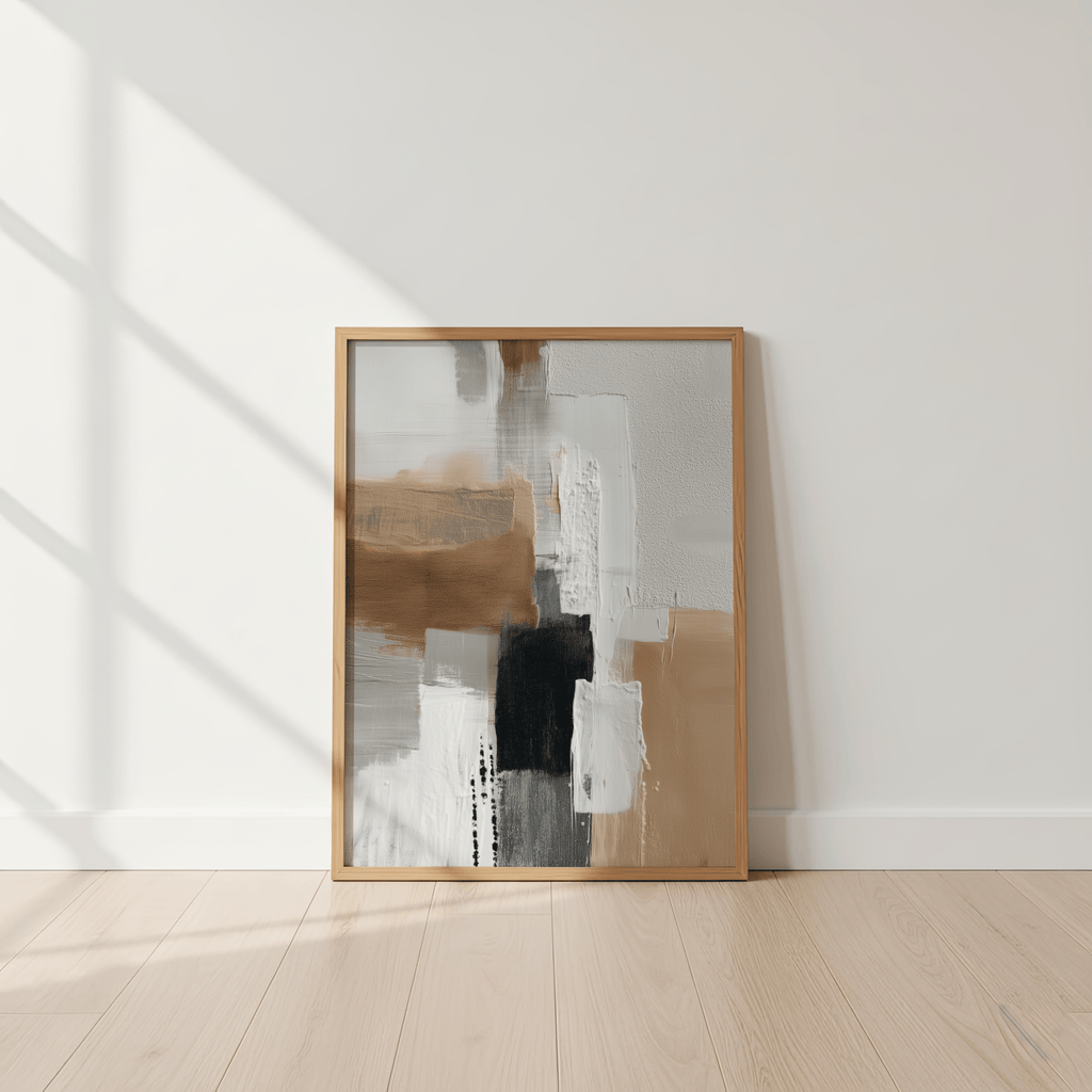 Abstract art piece in a wooden frame on a white wall