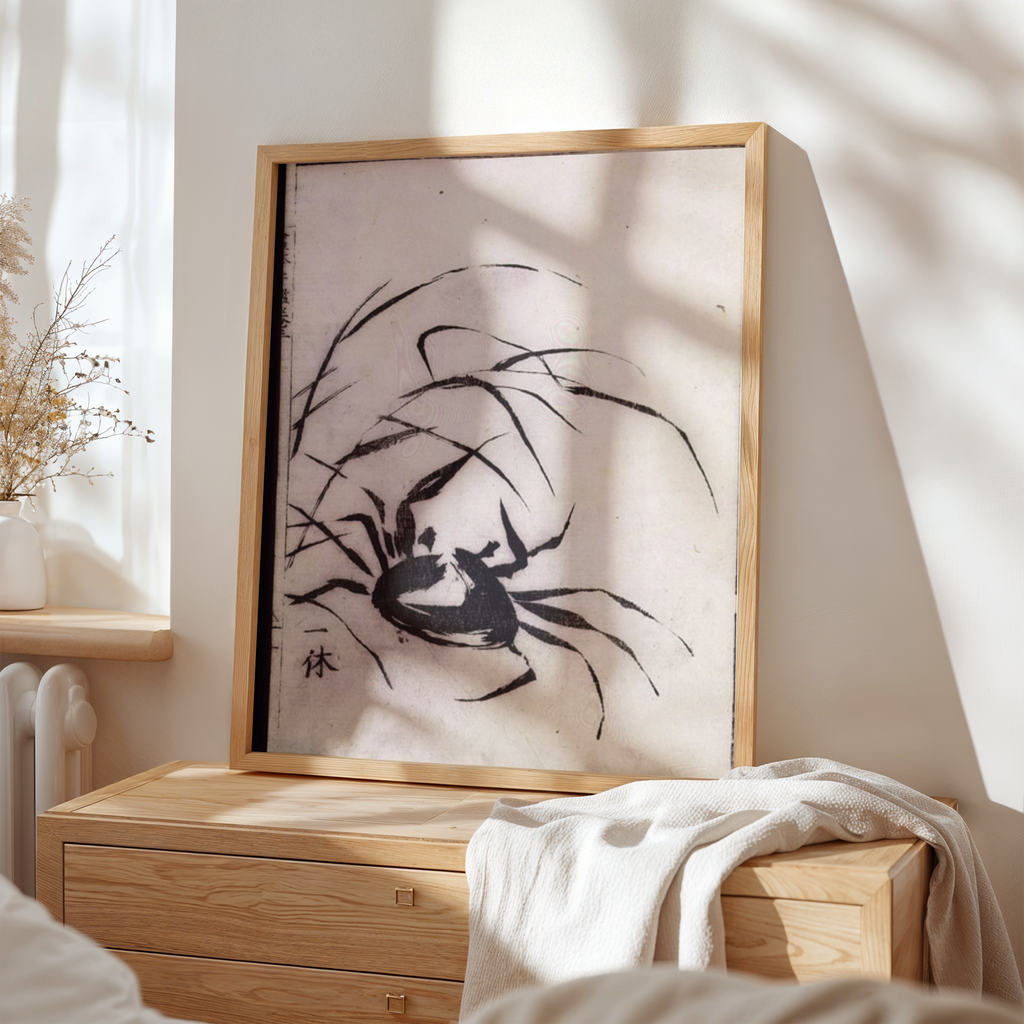 Framed artwork of a black spider on a white background, displayed in a room with wooden furniture and natural light.