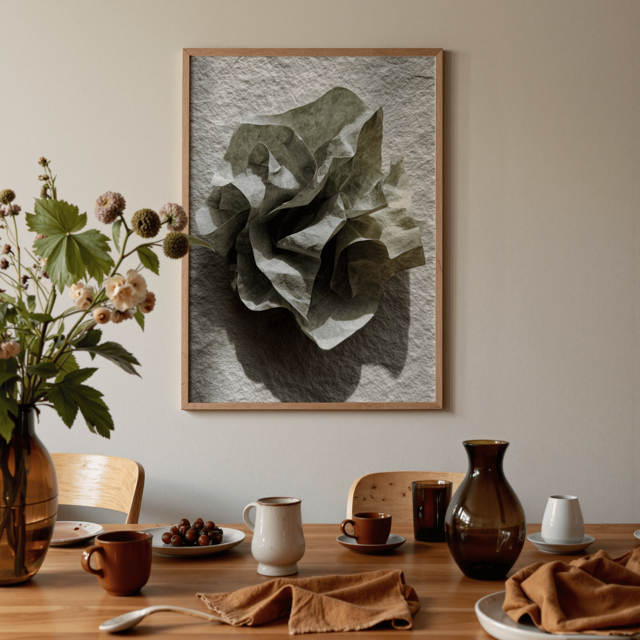 Dining room with a table set for a meal, featuring a large framed artwork of a green leaf on the wall.