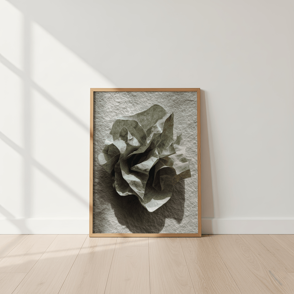 Framed artwork of a leaf on a textured background in a minimalistic room.