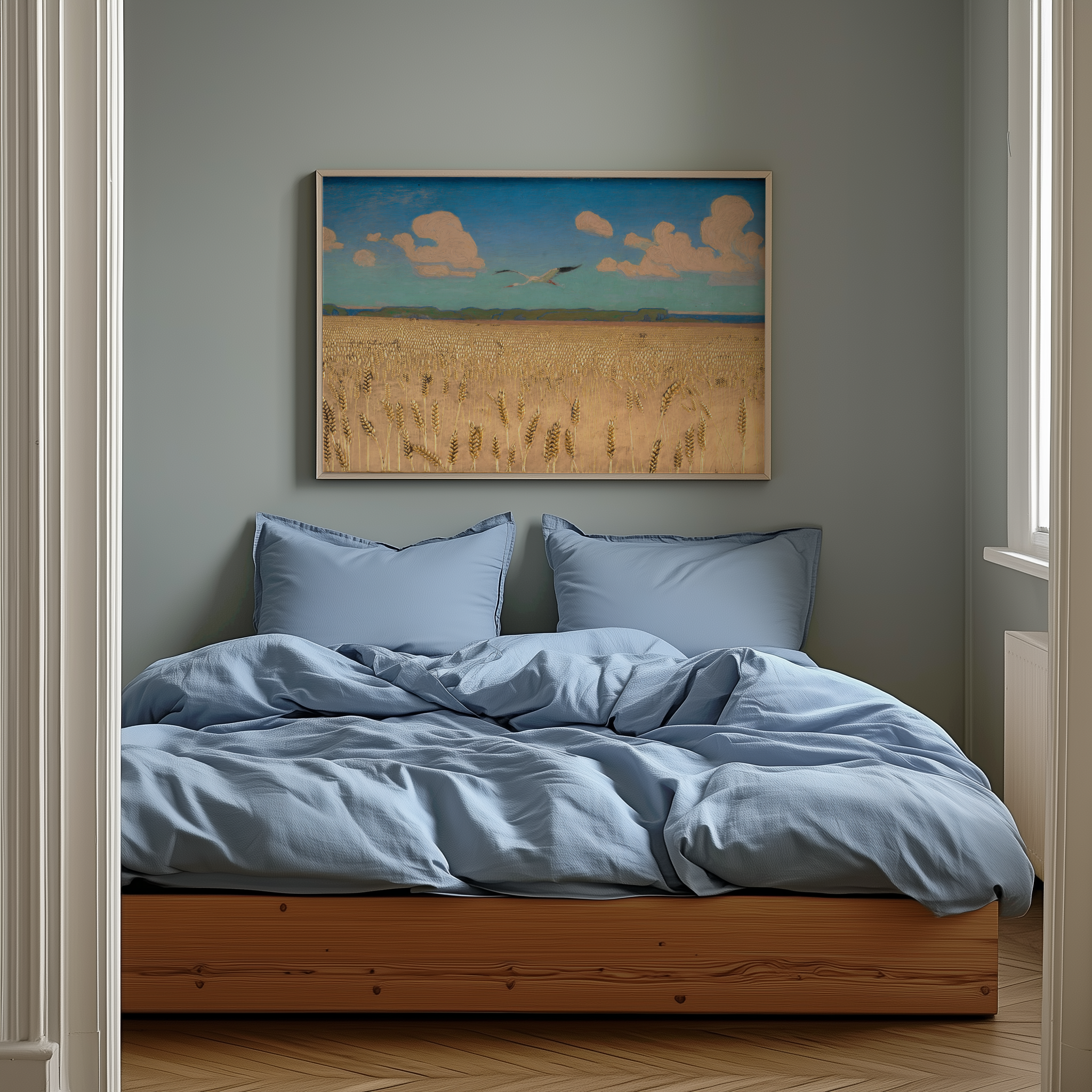 Bedroom with blue bedding and a framed landscape painting on the wall.
