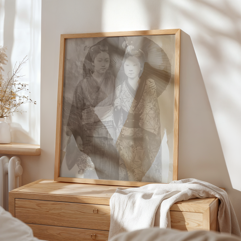 Framed black and white portrait of two women in traditional attire on a wooden dresser.