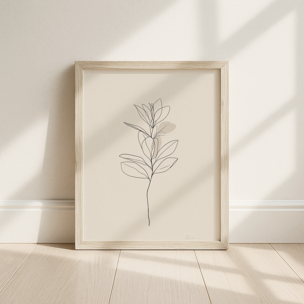Framed minimalist line art of a plant on a neutral wall.