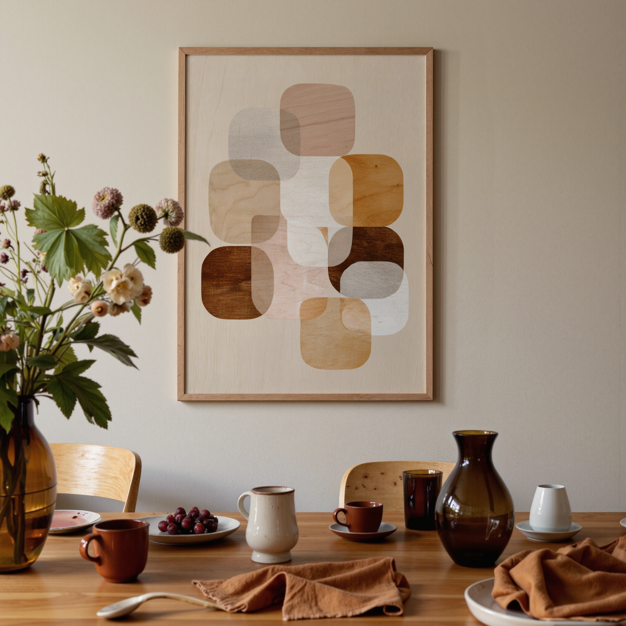 Dining room with a wooden table set for a meal, abstract art on the wall, and a vase with flowers.