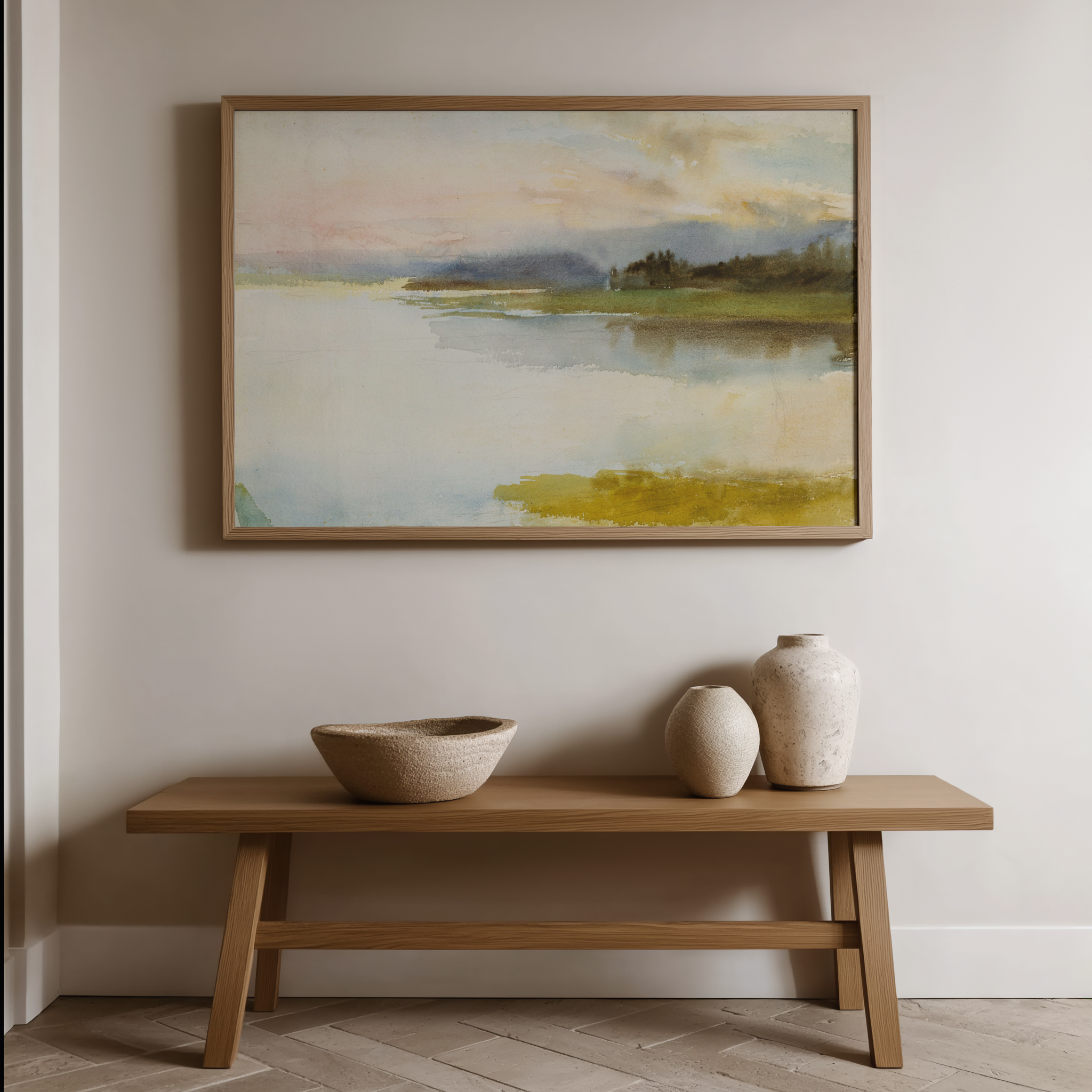 Wooden bench with ceramic bowls and vases against a wall with a framed landscape painting.