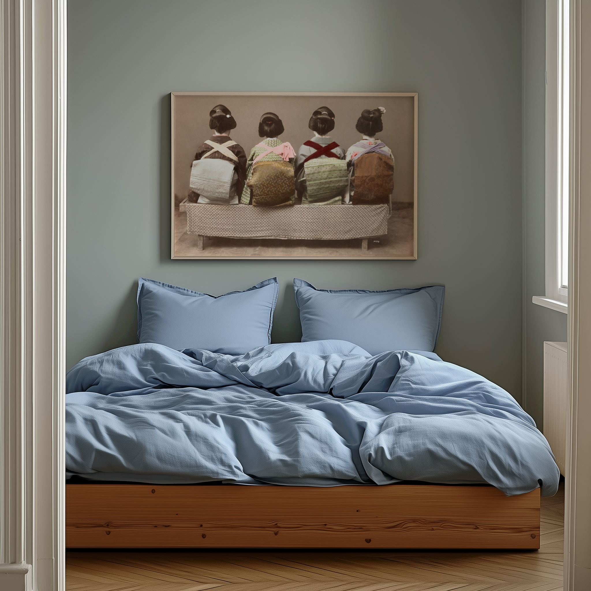 Bedroom with blue bedding and a framed artwork on the wall.