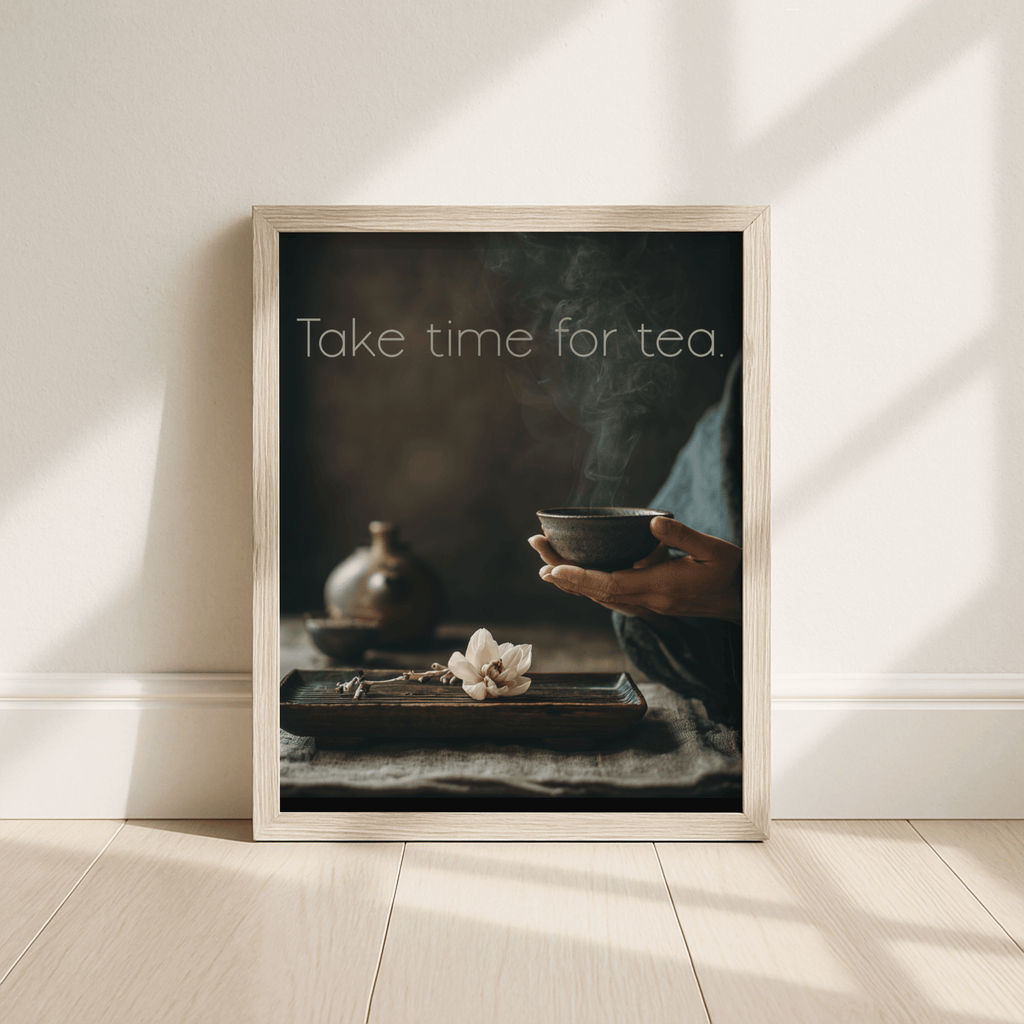 Framed artwork with a person holding a tea bowl and text 'Take time for tea' on a neutral background.